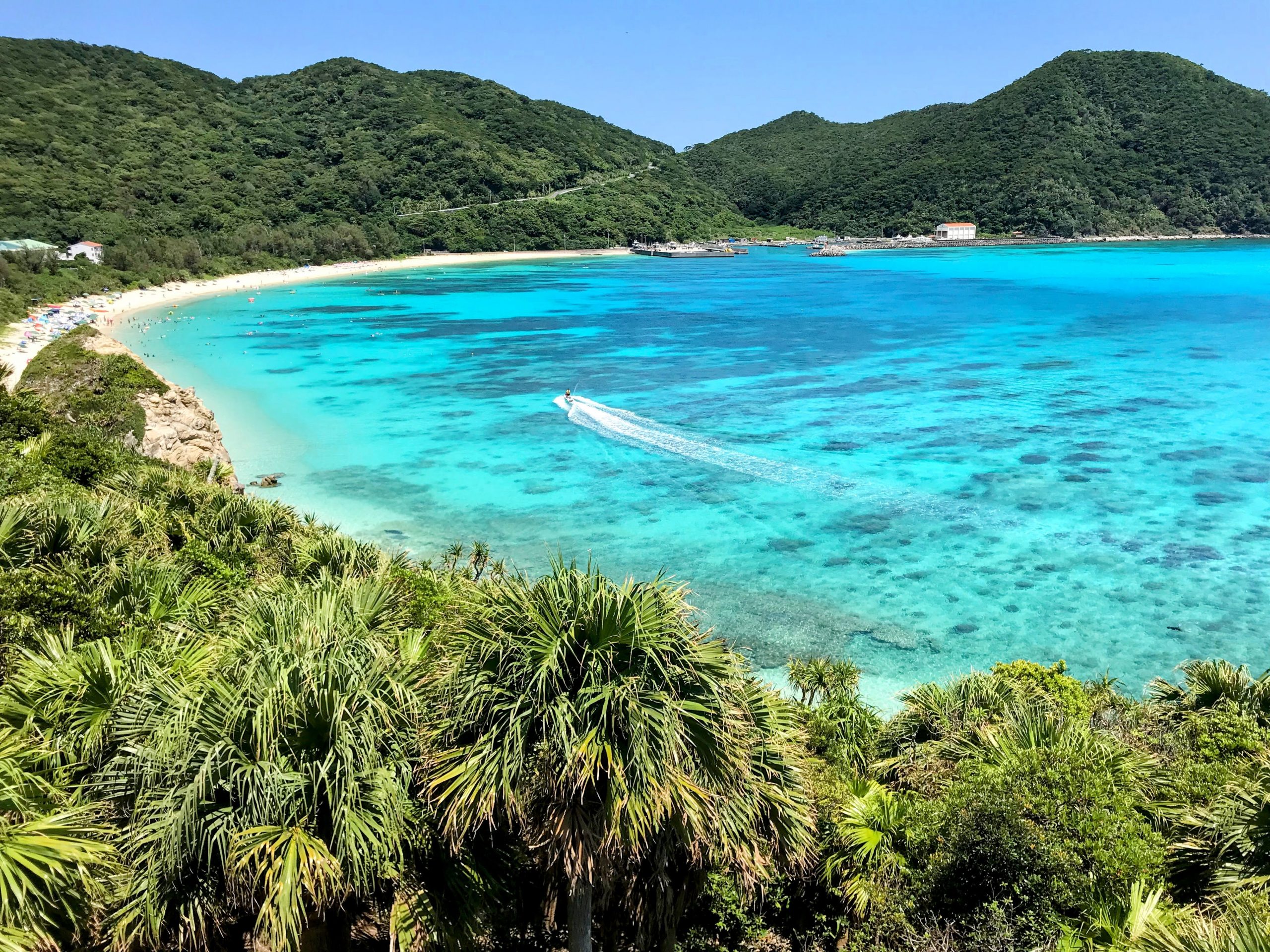 Aerial of Okinawa’s turquoise reefs and white-sand beaches